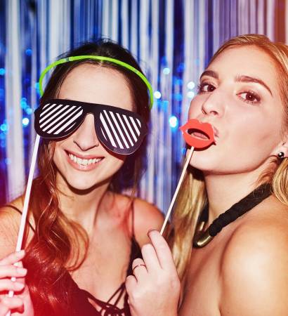 TGIF. Shot of two beautiful young women having fun with props in a photobooth TGIF. Shot of two beautiful young women having fun with props in a photobooth